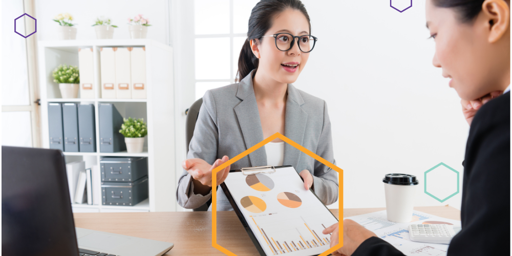 Female showing graphs on a clipboard
